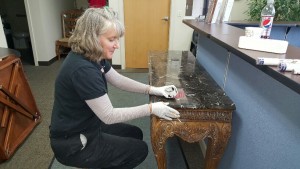 Furniture Medic team refinishing wooden table in Carol Stream IL